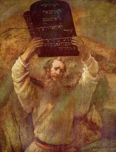 Moses holding the tablets of the ten commandments of God above his head