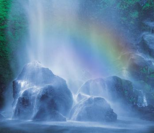 Misty waterfall with rainbow